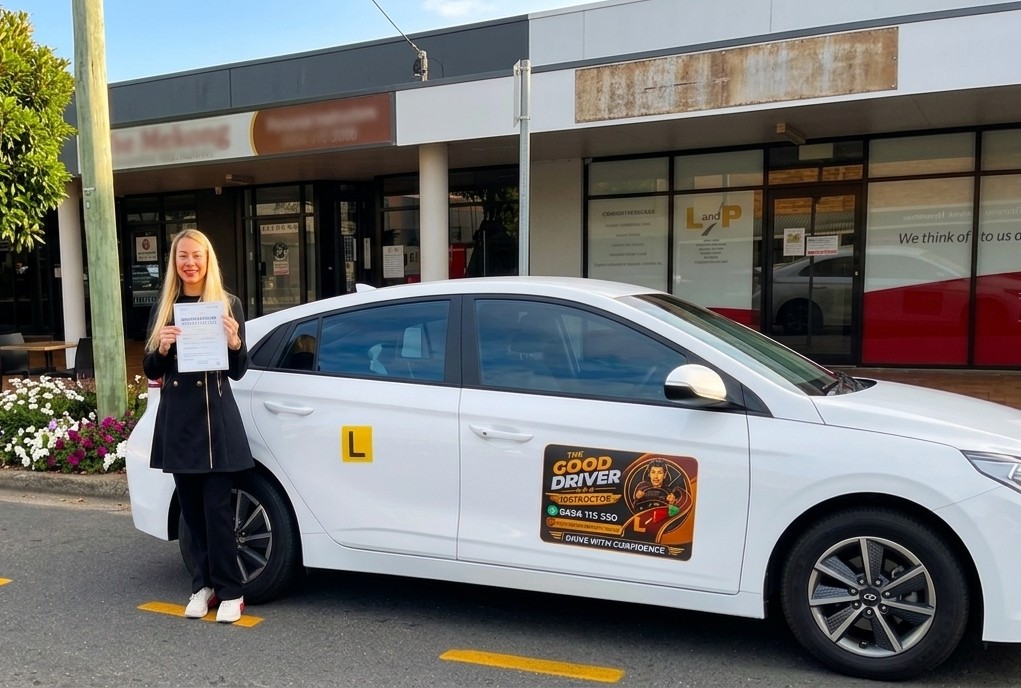 Student holding TMR driving test approval with The Good Driver Instructor car